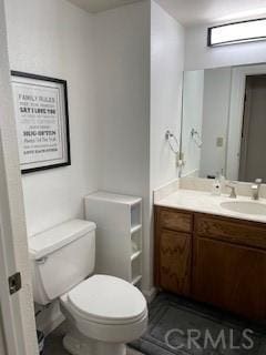 half bathroom with toilet and vanity