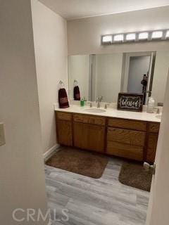 bathroom featuring wood finished floors and vanity