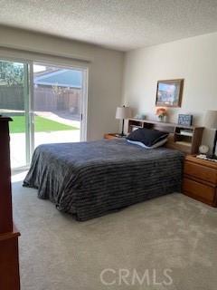 bedroom with a textured ceiling and carpet