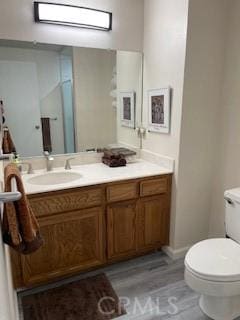 bathroom with toilet and vanity