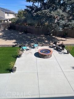 view of pool with a patio area, an outdoor fire pit, and fence