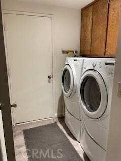 laundry area with washer and dryer and cabinet space