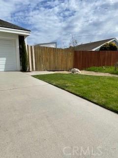 view of yard with a garage and fence