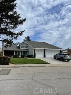 view of front of home featuring concrete driveway and a garage