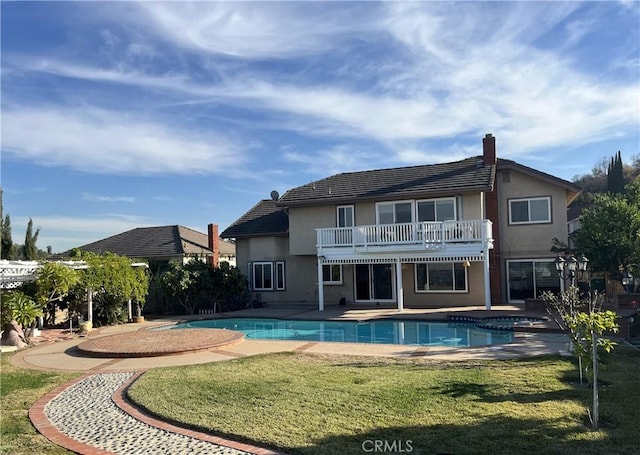 outdoor pool featuring a yard and a patio