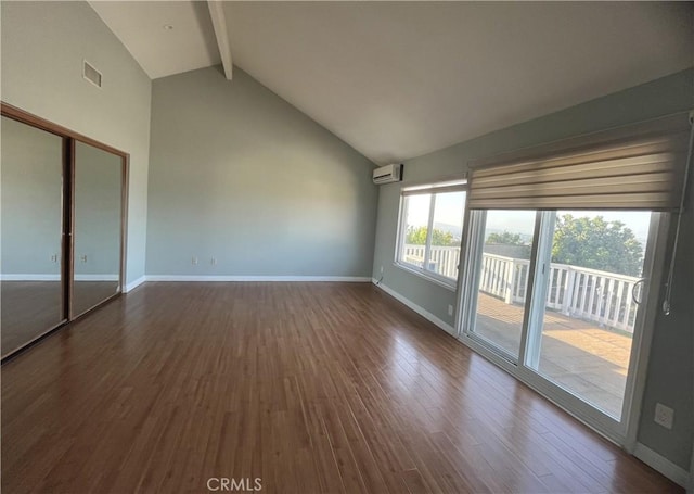 interior space featuring baseboards, visible vents, dark wood finished floors, beam ceiling, and a wall mounted air conditioner