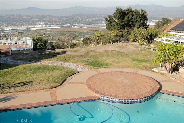 view of pool with a fenced in pool, a mountain view, a yard, and fence