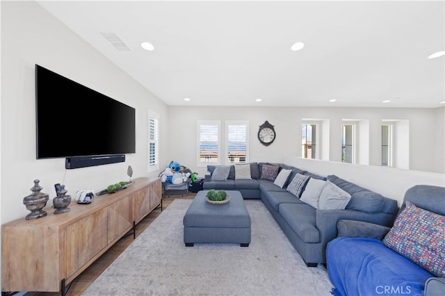 living area with recessed lighting, wood finished floors, and visible vents