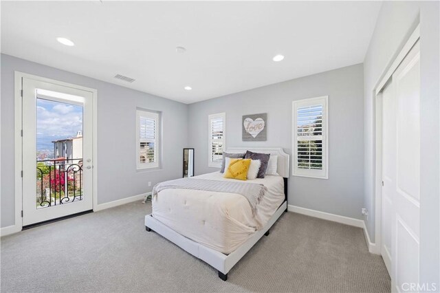 bedroom with access to outside, carpet flooring, baseboards, and visible vents