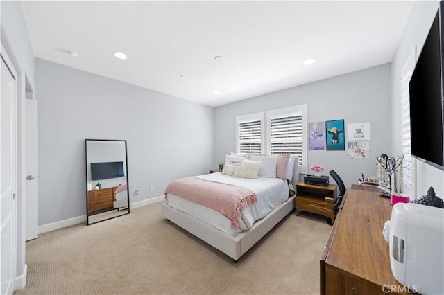 bedroom with recessed lighting, baseboards, and light carpet