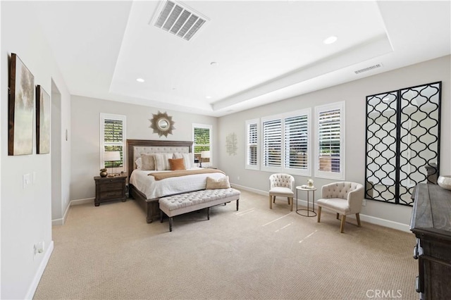 bedroom with visible vents, a raised ceiling, baseboards, and carpet flooring