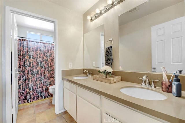 full bath featuring a sink, visible vents, toilet, and tile patterned flooring