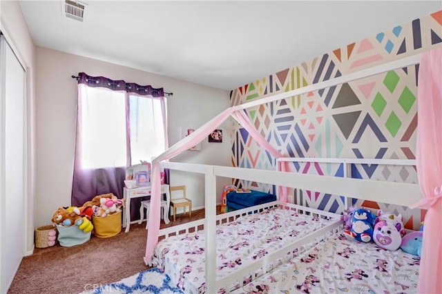 bedroom featuring visible vents, carpet floors, and a closet