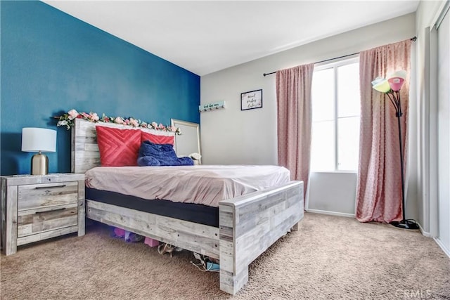 bedroom with carpet flooring and baseboards