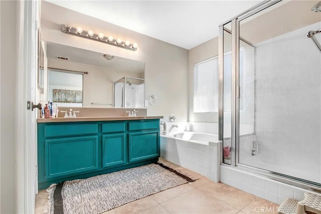 full bathroom featuring double vanity, a sink, a shower stall, a garden tub, and tile patterned floors