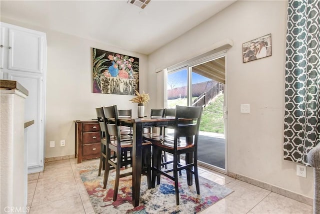 dining room with light tile patterned floors, visible vents, and baseboards