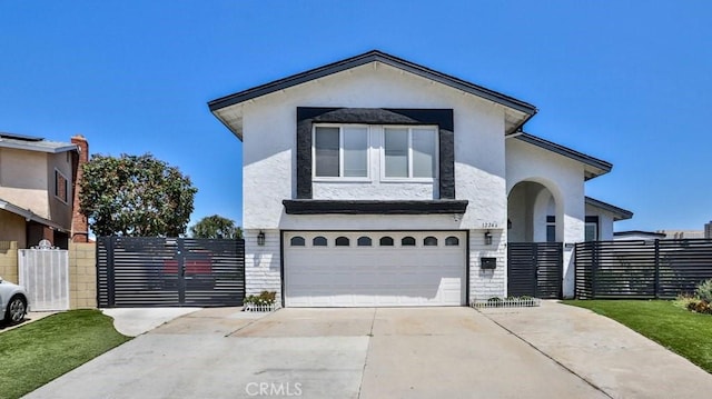 view of front facade featuring a garage, concrete driveway, stucco siding, and fence