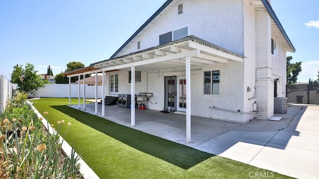 back of property with stucco siding, french doors, a fenced backyard, a patio area, and a pergola