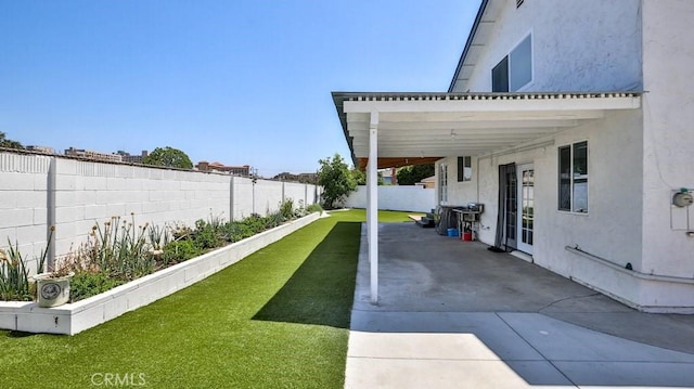 exterior space with french doors, a fenced backyard, and a patio