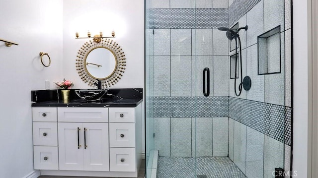 bathroom with a stall shower and vanity