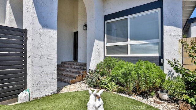 entrance to property with stucco siding