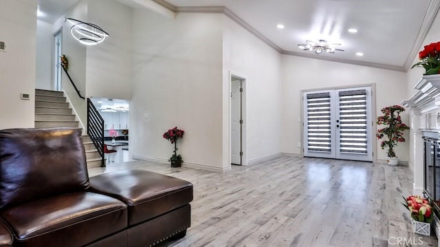 living area with light wood-type flooring, stairway, french doors, crown molding, and baseboards