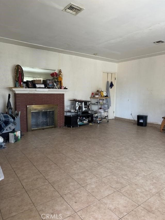 living area featuring a fireplace and visible vents