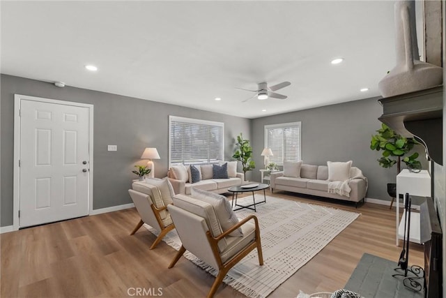 living area with recessed lighting, baseboards, light wood-style floors, and ceiling fan