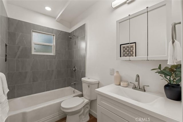 bathroom with toilet, vanity, and bathtub / shower combination