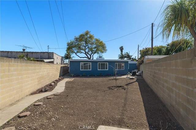 back of house featuring a fenced backyard