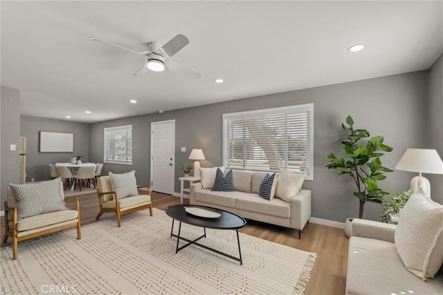 living room with recessed lighting, baseboards, a ceiling fan, and light wood finished floors