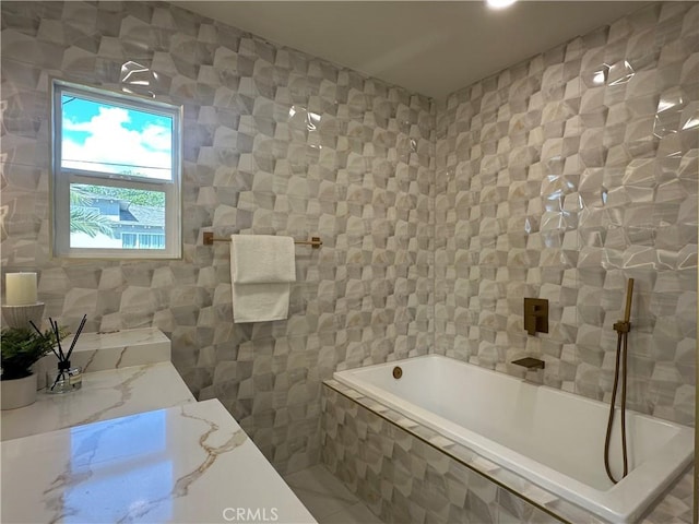 bathroom with tile walls and a relaxing tiled tub