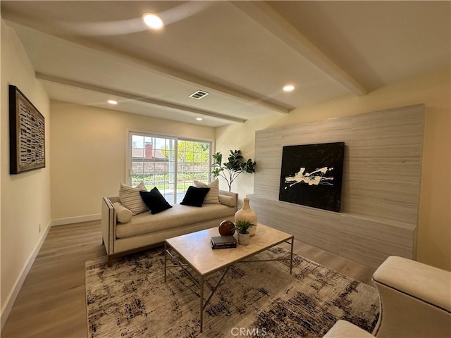 living area with visible vents, baseboards, beam ceiling, recessed lighting, and wood finished floors