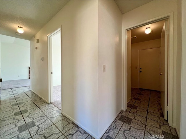 corridor featuring a textured ceiling