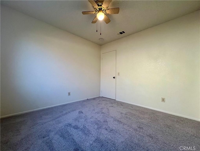 unfurnished room with visible vents, baseboards, carpet, and a ceiling fan