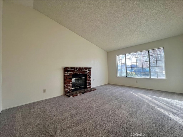 unfurnished living room featuring lofted ceiling, a brick fireplace, carpet floors, and a textured ceiling