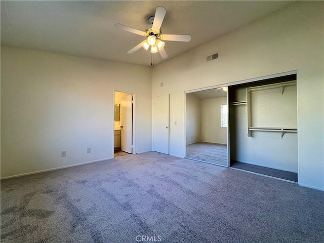 unfurnished bedroom featuring visible vents, baseboards, carpet floors, a closet, and a ceiling fan