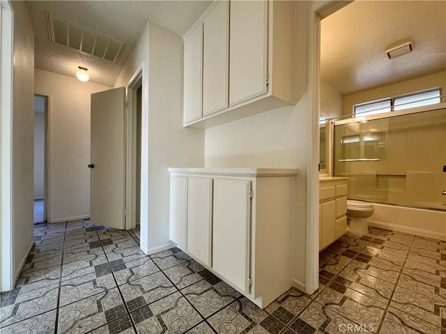 bathroom with visible vents, baseboards, vanity, shower / tub combination, and a textured ceiling