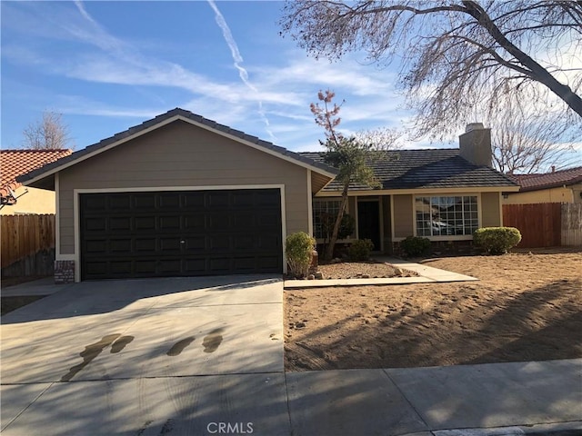 ranch-style home featuring fence, a garage, driveway, and a chimney