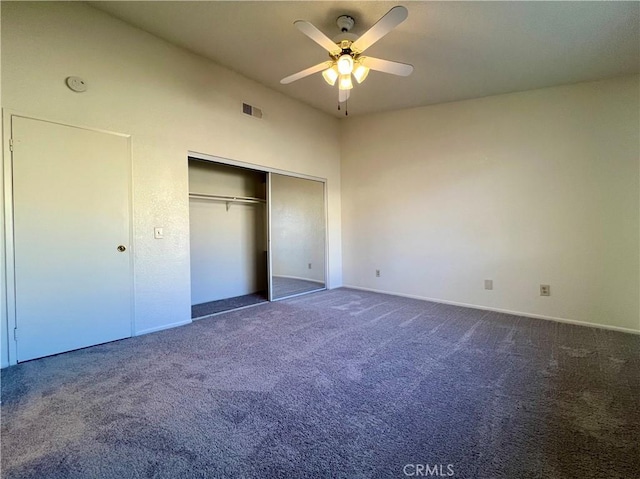 unfurnished bedroom featuring a closet, visible vents, ceiling fan, and carpet floors