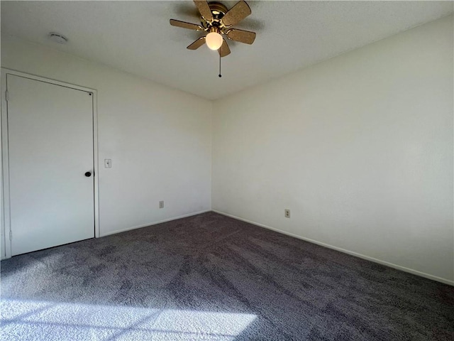 carpeted spare room with ceiling fan