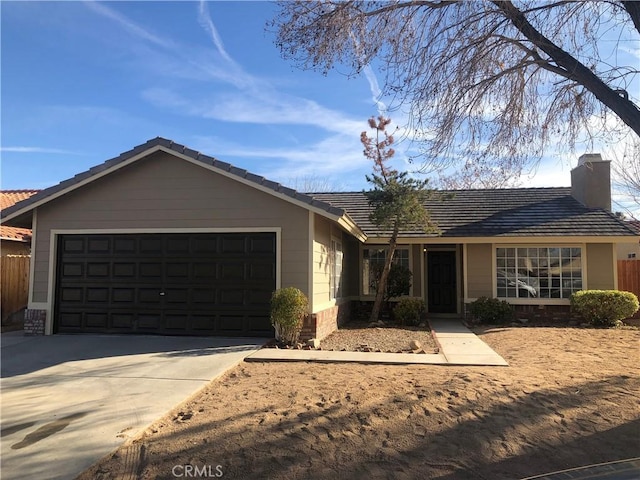 ranch-style home featuring concrete driveway, an attached garage, and a chimney