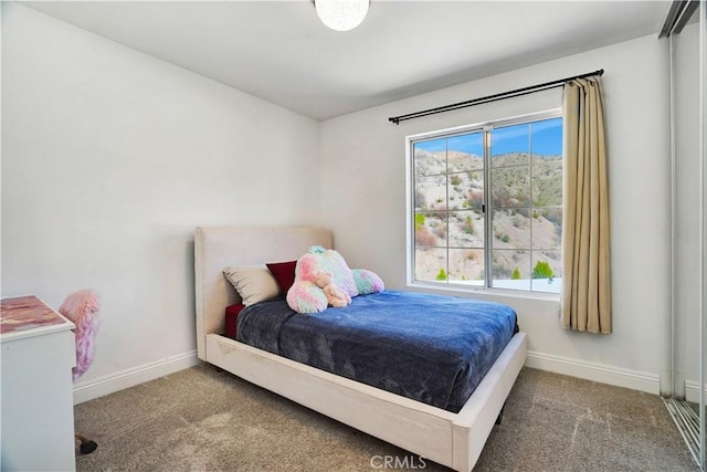 bedroom featuring carpet flooring and baseboards