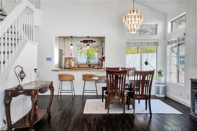 dining area featuring plenty of natural light, dark wood-type flooring, and high vaulted ceiling