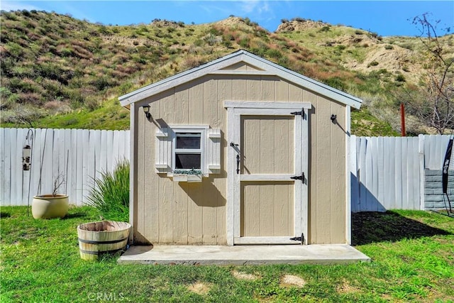 view of shed featuring a fenced backyard