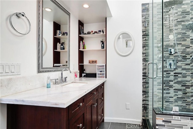 bathroom featuring recessed lighting, a shower stall, vanity, and baseboards