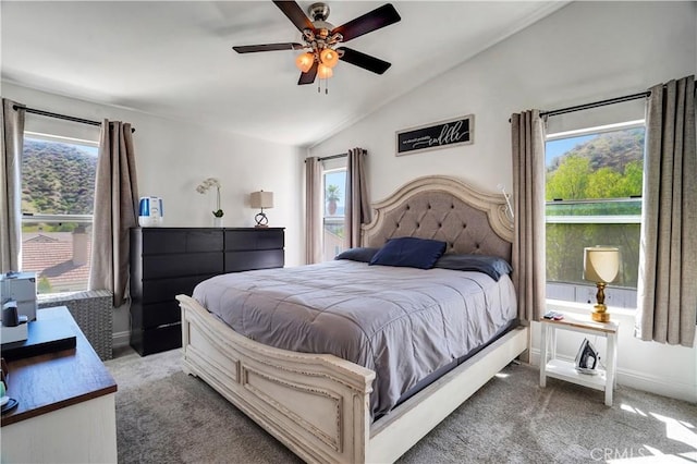 carpeted bedroom with baseboards, lofted ceiling, and ceiling fan