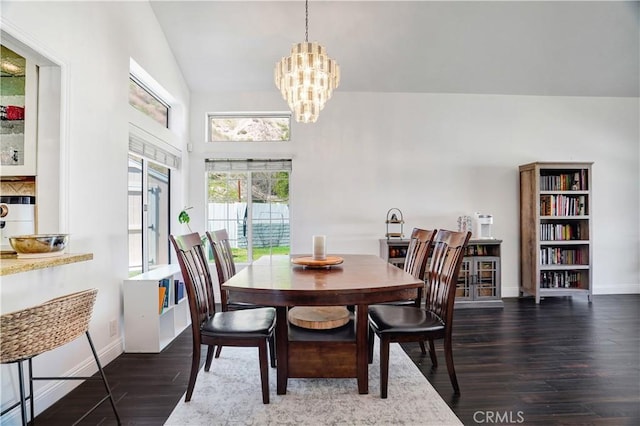 dining area with vaulted ceiling, baseboards, an inviting chandelier, and wood finished floors