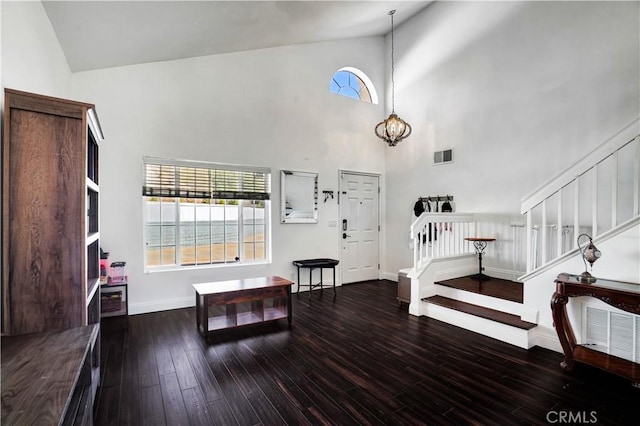 living area featuring a wealth of natural light, stairway, visible vents, and wood finished floors