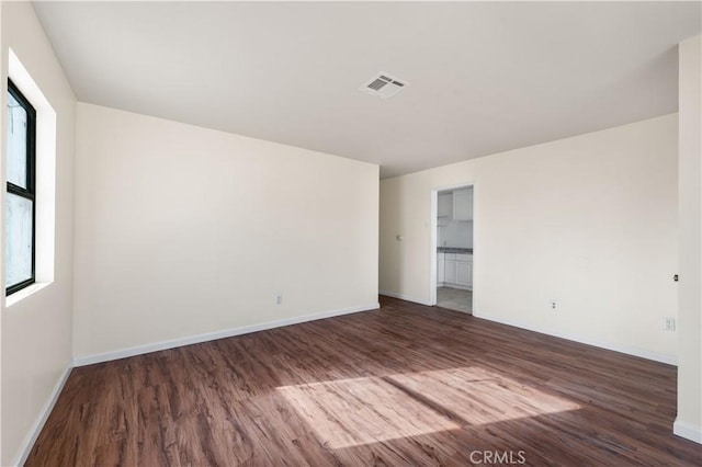43331 Fairglen Rd, Lancaster, CA 93535 - empty room featuring baseboards, a healthy amount of sunlight, visible vents, and wood finished floors